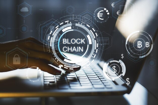 Man's hands on a laptop keyboard, in the foreground the inscription blockchain